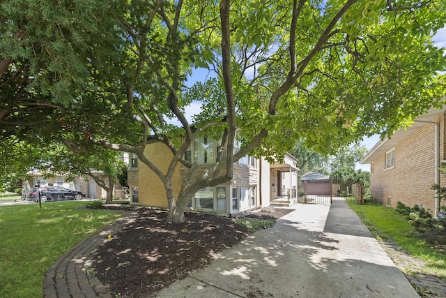 view of property hidden behind natural elements with a front lawn