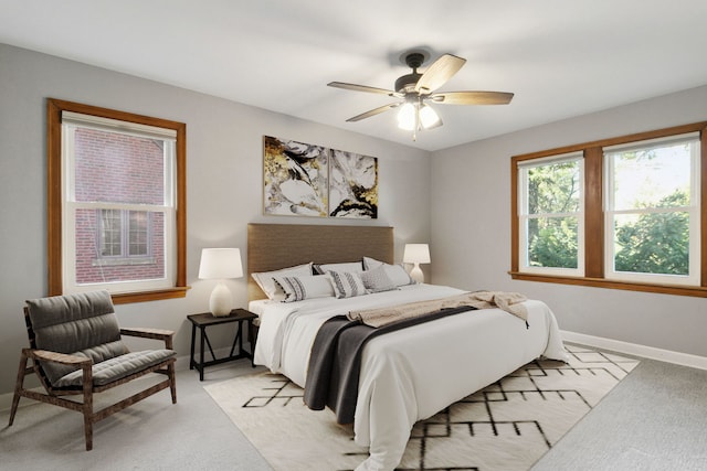 bedroom featuring ceiling fan and light colored carpet