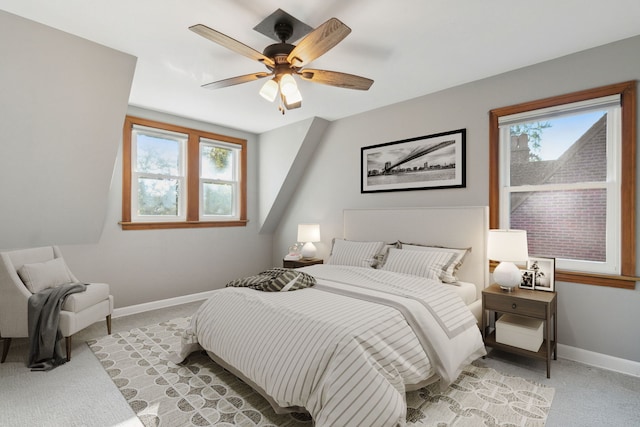 bedroom with ceiling fan and light carpet