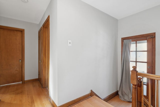 hallway with light hardwood / wood-style floors