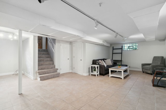 basement with light tile patterned floors and track lighting