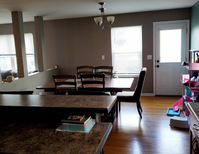 dining space with an inviting chandelier and wood finished floors