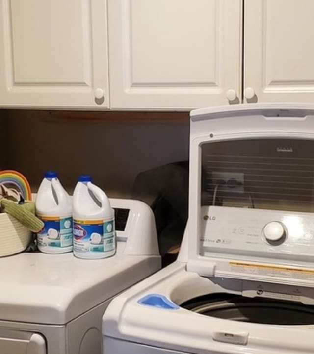 clothes washing area with washing machine and clothes dryer