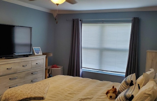 bedroom with ornamental molding and ceiling fan