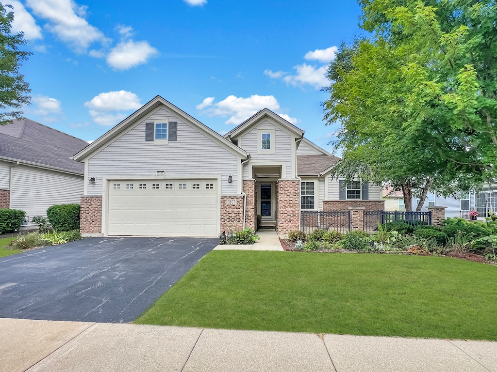 view of front of property with a garage and a front lawn