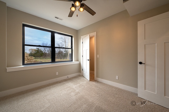 unfurnished bedroom featuring ceiling fan and light carpet