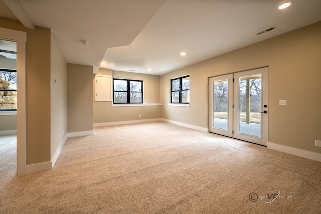 spare room featuring light carpet