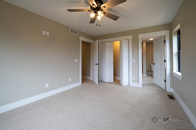 unfurnished bedroom featuring ceiling fan and light carpet