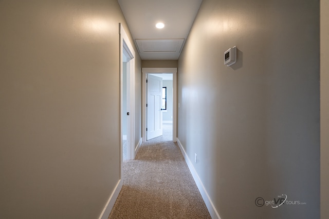 hallway featuring light carpet