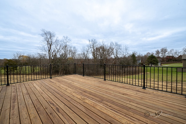 wooden terrace featuring a yard