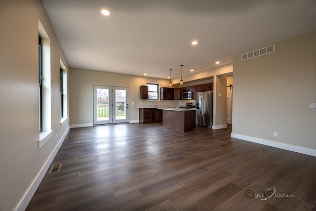 unfurnished living room with french doors, dark hardwood / wood-style floors, and sink