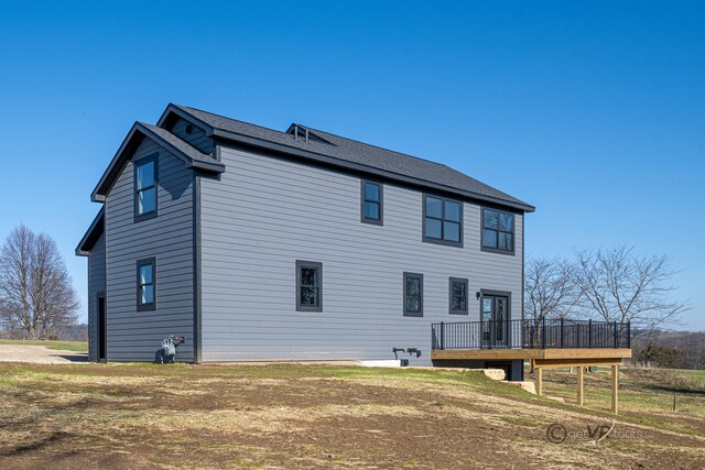 rear view of property with a wooden deck