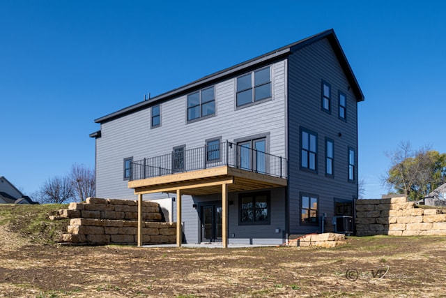 back of house with central air condition unit and a wooden deck