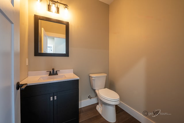 bathroom featuring hardwood / wood-style floors, vanity, and toilet