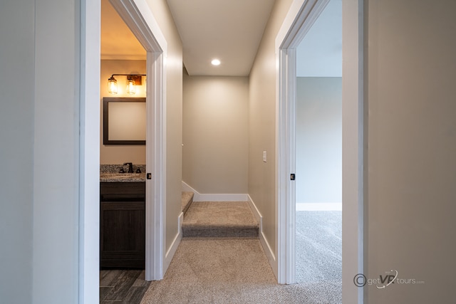 hall featuring carpet and sink