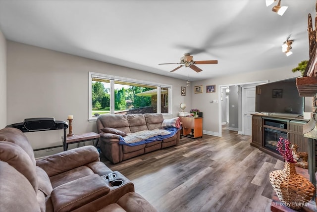 living room featuring ceiling fan and hardwood / wood-style flooring