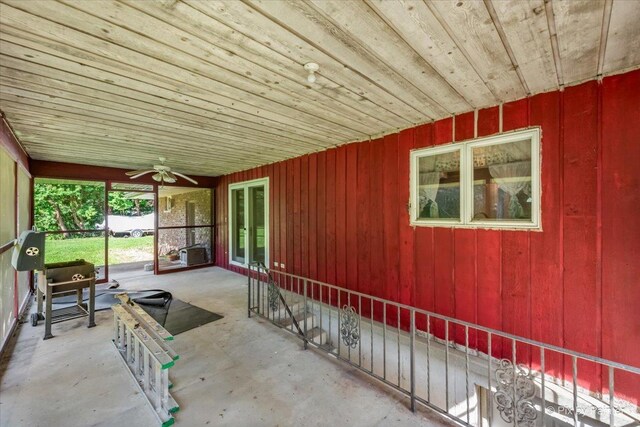 unfurnished sunroom featuring ceiling fan and wood ceiling