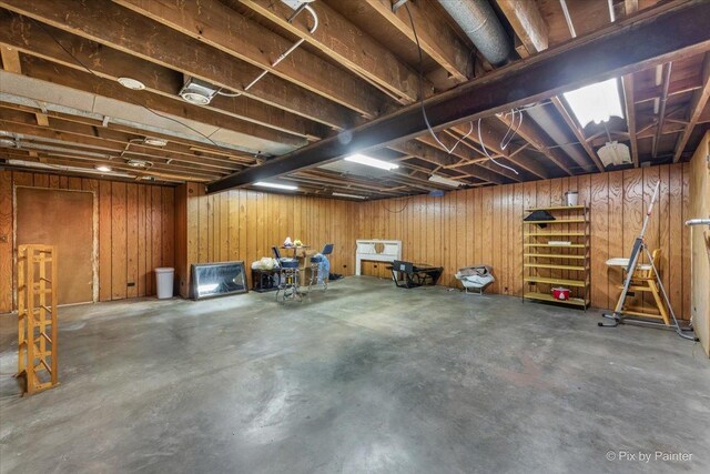 basement featuring wooden walls