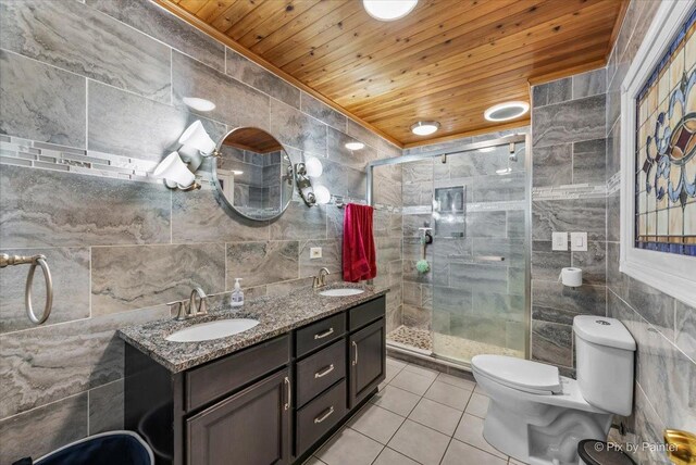 bathroom with a shower with shower door, vanity, tile walls, wood ceiling, and toilet