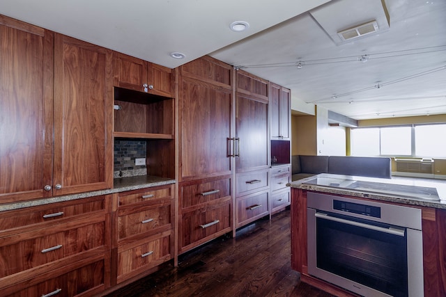 kitchen with oven and dark hardwood / wood-style floors