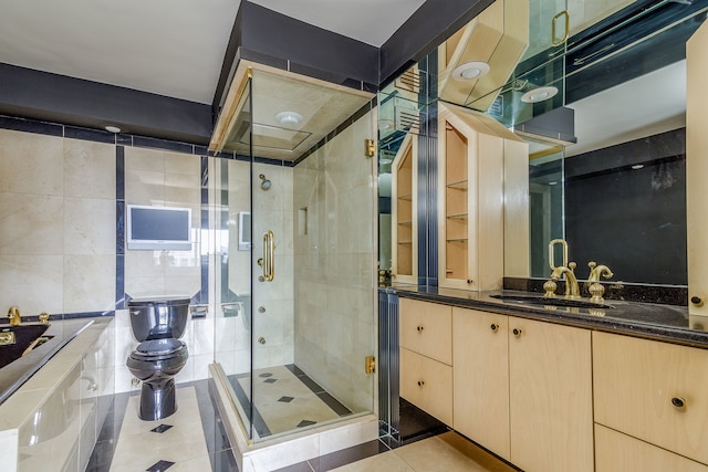 bathroom featuring tile patterned flooring, a shower with door, toilet, and vanity