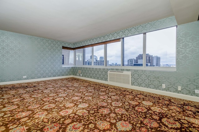 1440 N Lake Shore Dr Unit 22Abcd, Chicago, IL 60610 - unfurnished room with baseboards, a city view, wallpapered walls, and carpet