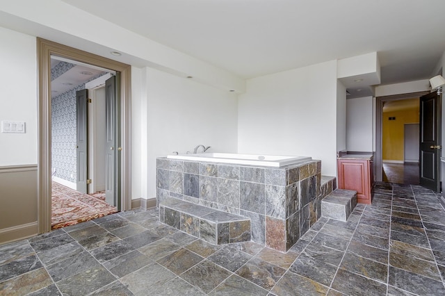 1440 N Lake Shore Dr Unit 22Abcd, Chicago, IL 60610 - bathroom with baseboards, a bath, and stone tile flooring