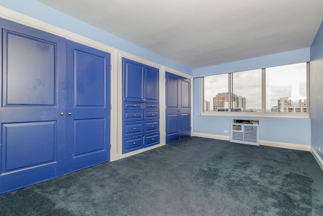 1440 N Lake Shore Dr Unit 22Abcd, Chicago, IL 60610 - unfurnished bedroom with baseboards, dark carpet, two closets, and heating unit