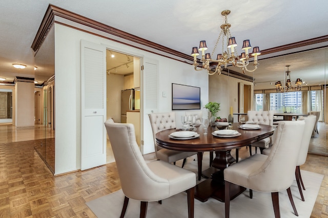 dining area with a textured ceiling, crown molding, light parquet flooring, and a notable chandelier