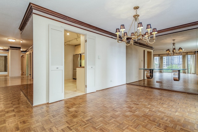 spare room with a textured ceiling, crown molding, light parquet flooring, and a chandelier