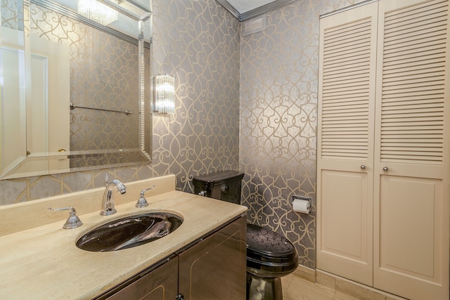 bathroom featuring vanity, crown molding, toilet, and tile patterned flooring