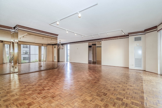 unfurnished room with parquet floors and rail lighting