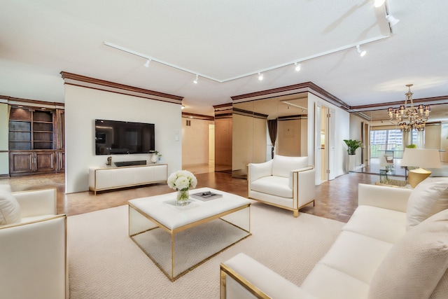 living room featuring crown molding, light hardwood / wood-style floors, track lighting, and a chandelier