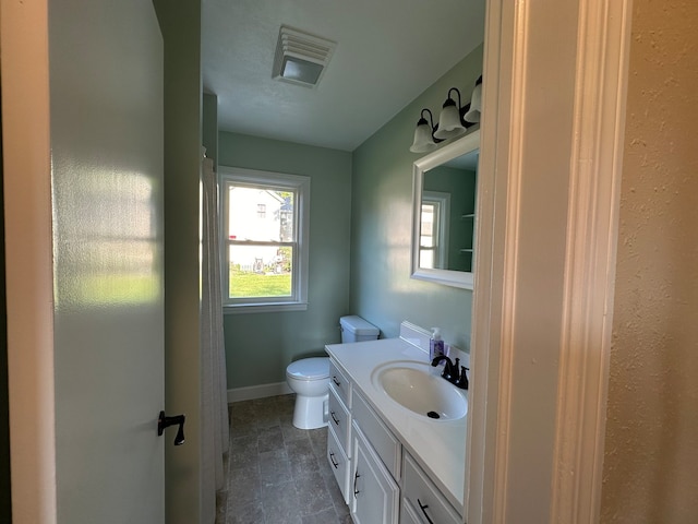 bathroom featuring tile patterned floors, toilet, and vanity