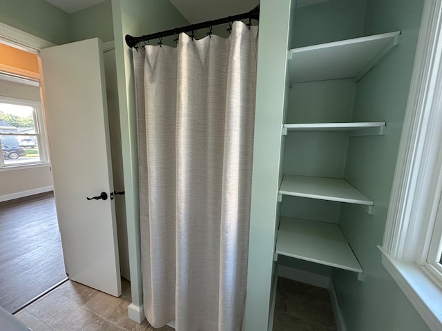 bathroom with hardwood / wood-style floors