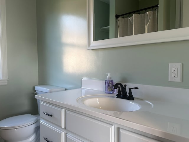 bathroom with toilet and vanity