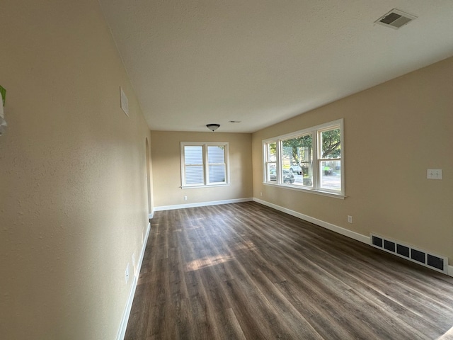 unfurnished room with wood-type flooring