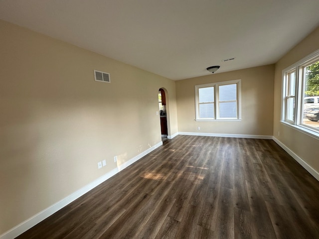 empty room with dark wood-type flooring