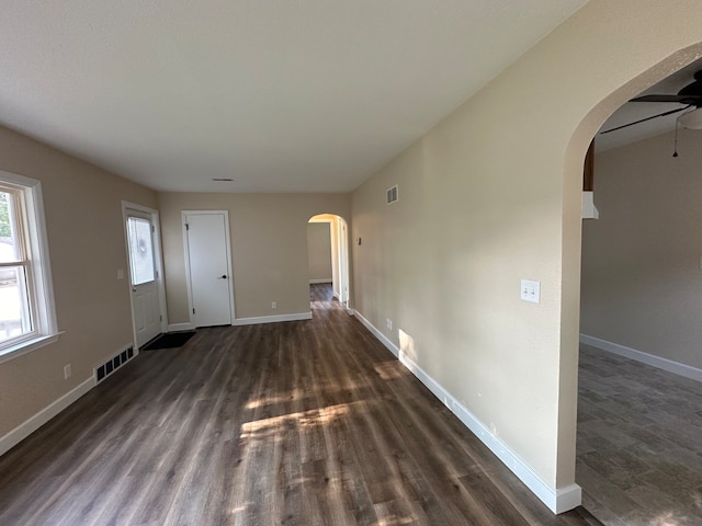 empty room with ceiling fan and dark hardwood / wood-style floors