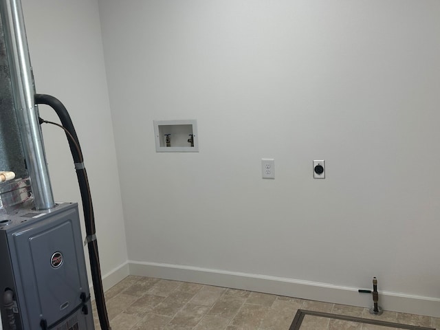 washroom with hookup for an electric dryer, hookup for a washing machine, and light tile patterned flooring