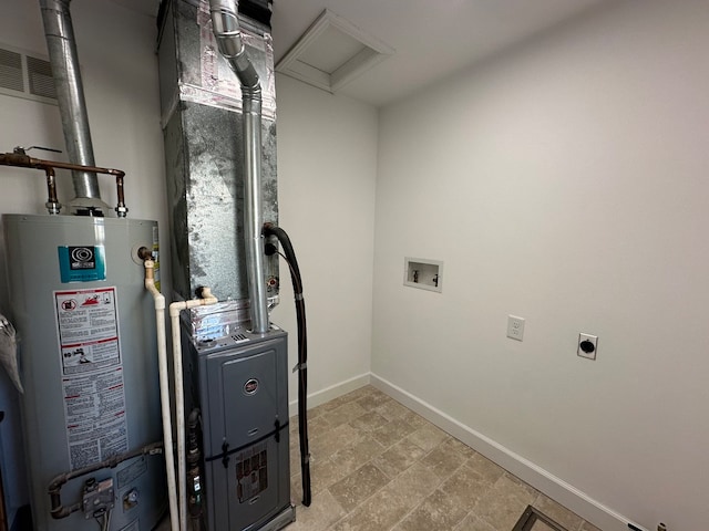 utility room featuring water heater