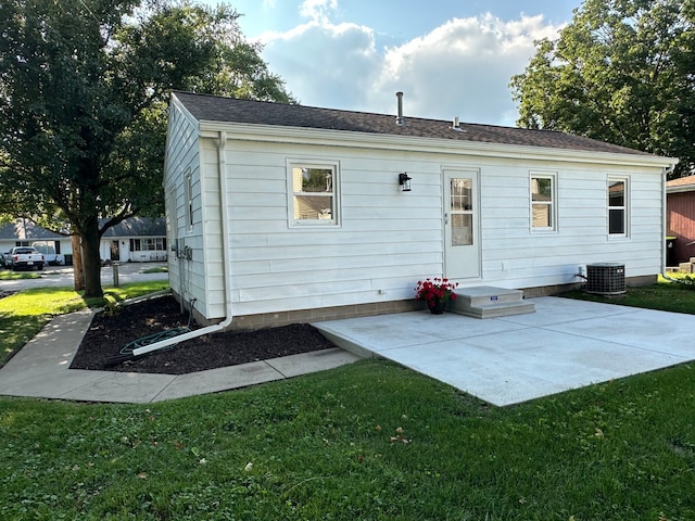 back of house with a lawn, a patio, and central air condition unit