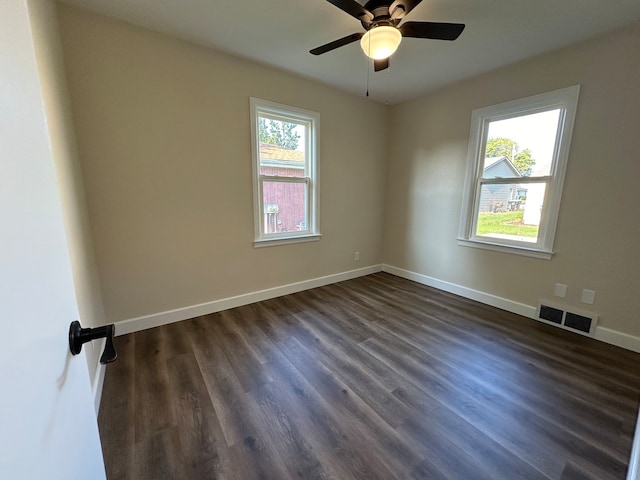 unfurnished room with ceiling fan, dark hardwood / wood-style floors, and a healthy amount of sunlight