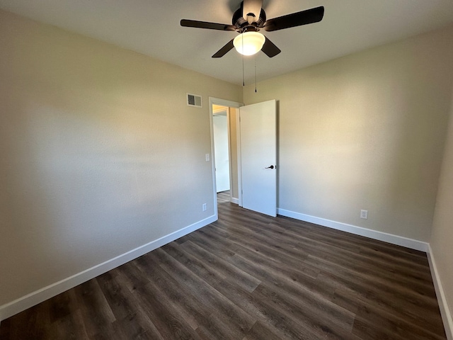 spare room with ceiling fan and dark hardwood / wood-style floors