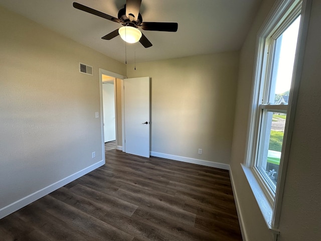 spare room featuring ceiling fan and dark hardwood / wood-style flooring