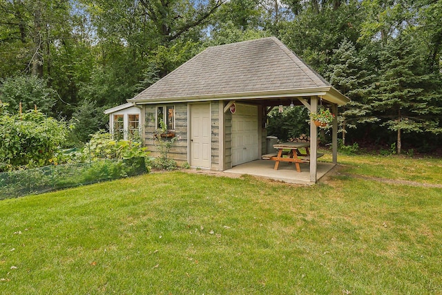 view of outbuilding with a lawn and a garage