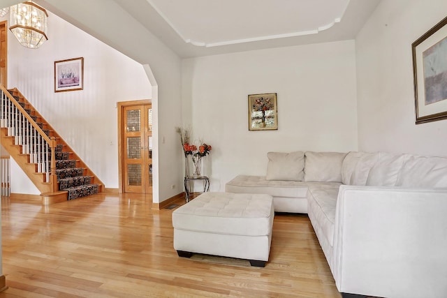 living room featuring a notable chandelier and light wood-type flooring