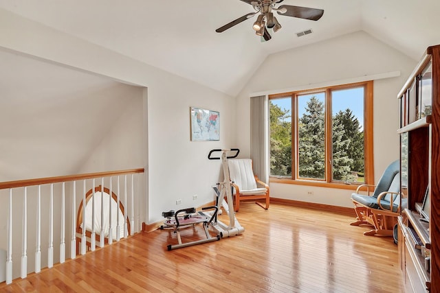 living area featuring ceiling fan, vaulted ceiling, and light hardwood / wood-style flooring