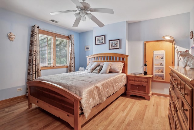 bedroom with ceiling fan and light hardwood / wood-style floors