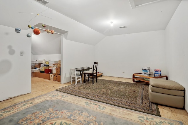 sitting room featuring lofted ceiling and wood-type flooring